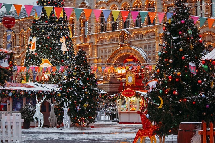 New Year fair with decorated fir trees outside GUM on Red Square in Moscow